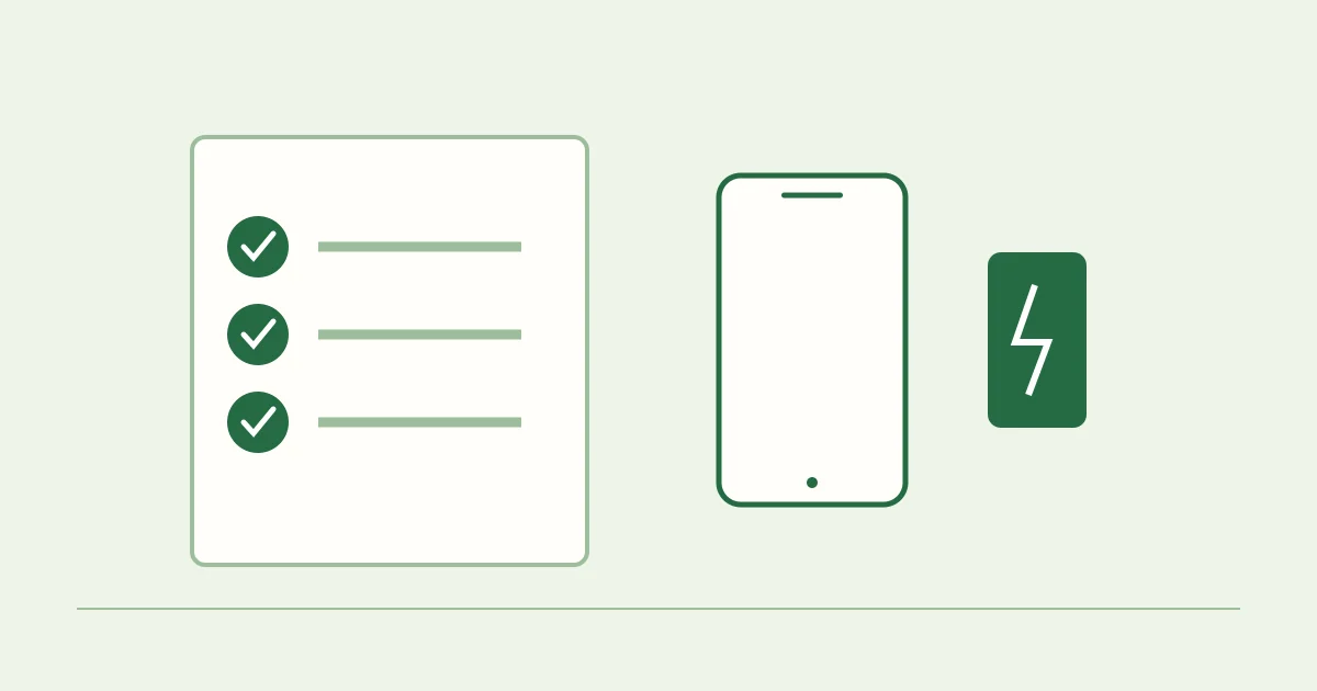 A travel preparation sheet next to a phone, card and spare battery.
